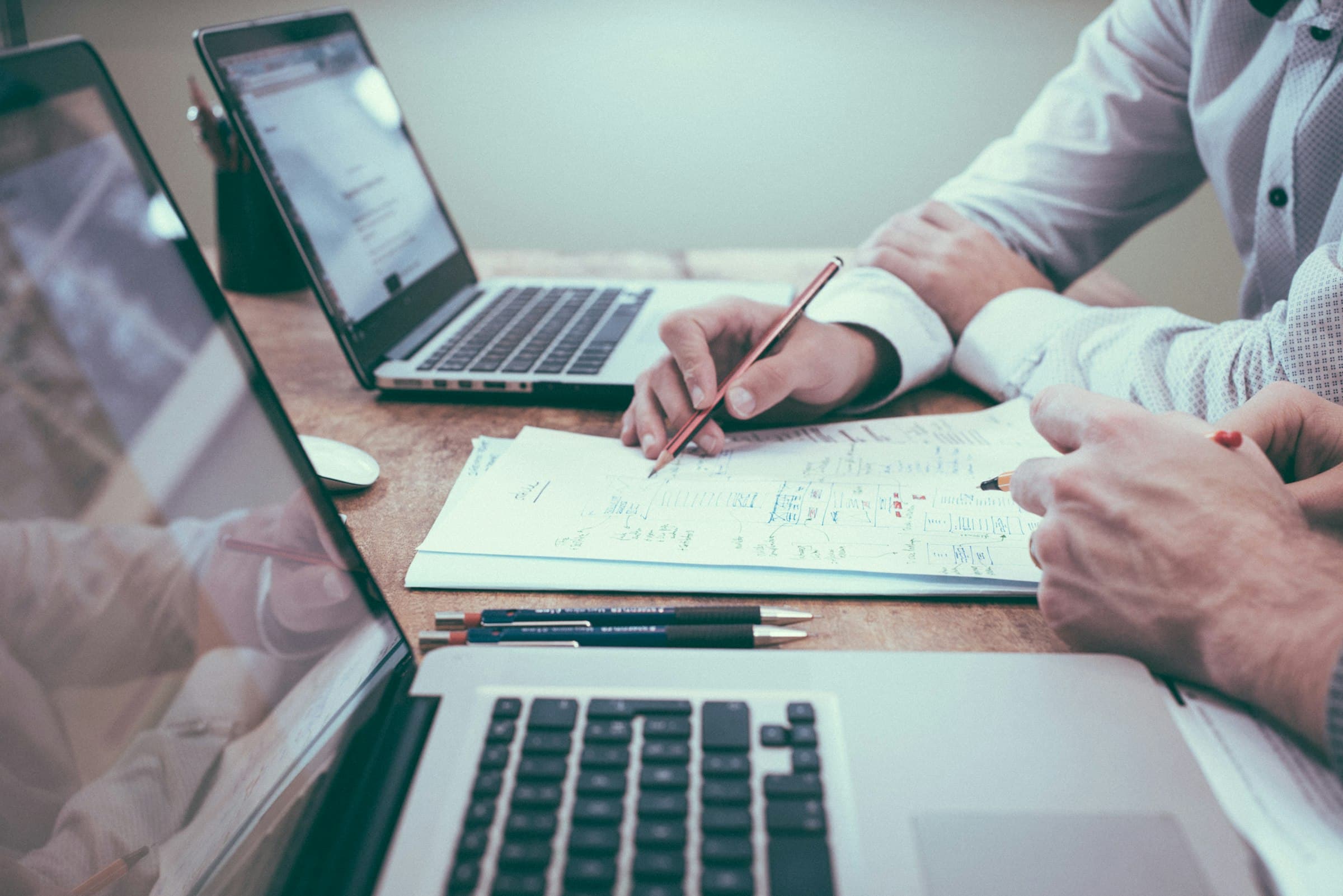 Business owner meeting with accountant to review financial documents and growth strategy
